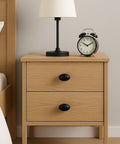 Wooden nightstand with Oval Matte Black Cabinet Knobs 10 Pack For Kitchen And Furniture By EAXINTA Modern Single Hole Hardware installed.