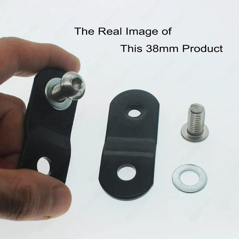 Hand holding black 38mm steel riser from Gas Tank Rising Lift Kit For Harley Big Twin Dyna Softail Touring Bikes 1 pair