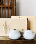 Premium Ceramic Tea Canister Set For Kitchen Straight Up Airtight Coffee Bean Storage Jar with two blue jars on a wooden table.