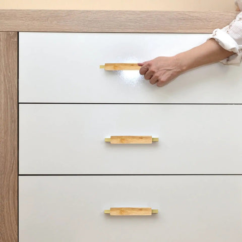 Sleek Dope Solid Wood Cabinet Pull Handle Set For Cabinets, 96mm Aluminum Wood Bar Pull With Gold Finish, shown on white drawers