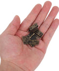 Person holding 1:12 Scale Miniature Bronze Hinges Set Of 20 With 80 Screws For Dollhouse Furniture Cabinet Closet DIY Projects Antique Brass Finish