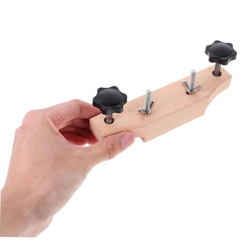 Hand holding Guitar Bridge Clamp Repair Tool Set For Acoustic Guitars Pro Luthier Wrench Kit; wood and metal construction visible.