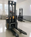 Top Tier Electric Walkie Pallet Stacker With Huge 1500Kg Capacity in a warehouse, showcasing steel frame and lifting capacity.