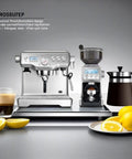 Top Shelf Dual Boiler Espresso Machine Paired With Smart Grinder System For Brewing Hella Smooth Specialty Brews And Flawless Microfoam Milk For Weekend Barista Sessions, silver color, coffee beans and lemon slice in foreground.