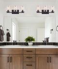 Matte Black Four Light Vanity Fixture With Clear Glass Shades above bathroom mirror, sleek farmhouse style lighting