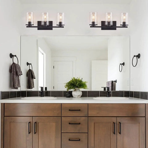 Matte Black Four Light Vanity Fixture With Clear Glass Shades above bathroom mirror, sleek farmhouse style lighting