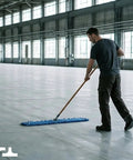 No Sweat Heavy Duty Commercial Floor Sweeper With A Slick Forty Eight Inch Reusable Washable Dust Mop Head and Sturdy Wooden Handle for Quick Hardwood Tile Laminate Floors In Bold Blue in use on a large floor.
