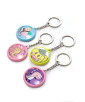 Four colorful keychains from 50 Pack Keychain Button Making Kit For 1.25 Inch Button Makers, featuring cartoon designs.