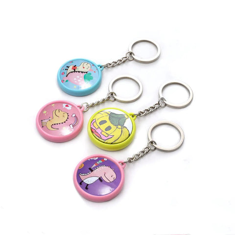 Four colorful keychains from 50 Pack Keychain Button Making Kit For 1.25 Inch Button Makers, featuring cartoon designs.