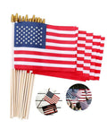 12 Pack Handheld 5x8 Inch American Flags On Wooden Sticks with Safe Spear Tops displayed for patriotic events and decor.