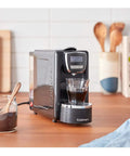 Kickstart Your Daily Grind With This Total Game Changer Black Espresso Machine on kitchen counter with espresso shot.