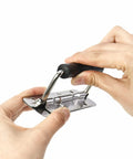 Hands holding stainless steel spring loaded case handle with rubber grip 304 grade for cabinets, wardrobes, drawers, garage storage