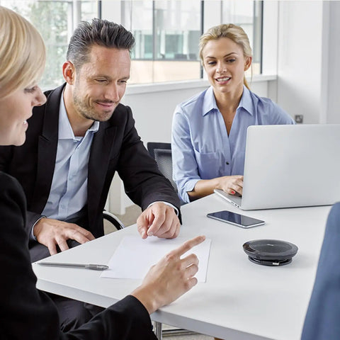 People in a meeting room with Speak 510 Portable Conference Speaker for meetings and calls with rock solid sound on table.