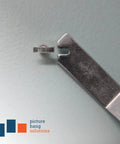 Close-up of Hella Durable T Head Security Wrench For Picture Frame Installation With Tough Steel Build for inserting locking screws.