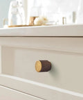 Single 6 Pack Antique Brass Cabinet Knob Set With Zinc Alloy Construction on white drawer front.