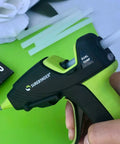 Hand holding a mini glue gun with All Purpose Mini Hot Glue Sticks For Crafts And Repairs, 4 Inch Length By 0.27 Inch Diameter, Clear