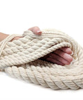 Hand holding 100 Percent Cotton Twisted Rope White Half Inch By 320 Feet USA Made Natural Cord For Macrame Crafts Baker And Butchers Twine Knotting Pet Toys