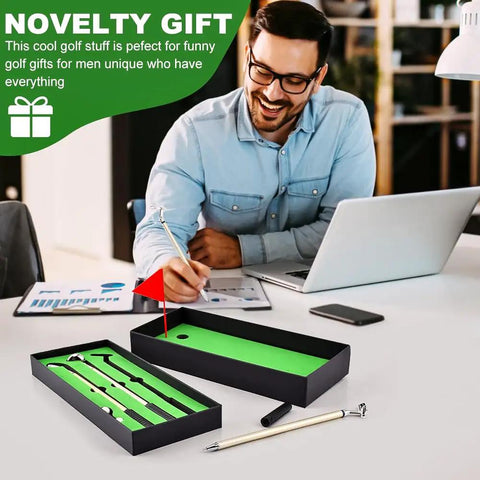 Man smiling at desk with Awesome Golf Pen Set With Mini Desktop Putting Green And Ball Pens, a unique gift idea.