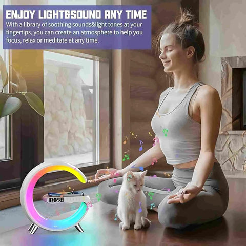 Woman meditating with Bluetooth Speaker Lamp With Wireless Charger And App Control, RGB Night Light, Alarm Clock, and a cat.