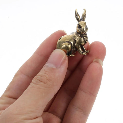 Hand holding Solid Brass Rabbit Cabinet Pull Set With Vintage Brass Knobs Antique Finish Drawer Pulls for kitchen cabinets