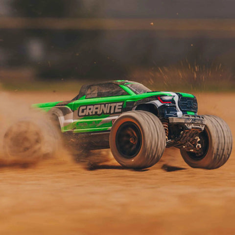 1/18 Scale Granite GROM Mega 380 Brushed 4x4 Monster Truck RTR kicks up dirt in off-road action, green body visible