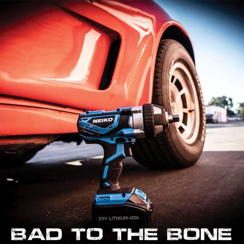 Cordless Impact Wrench Kit With Half Inch Drive Monster Torque 20V Lithium Battery by a car tire on pavement