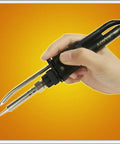 Hand holding 4 In 1 Digital Hot Air Rework And Soldering Station With 70W Soldering Iron, Vacuum Pickup And Smoke Absorber