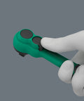 Gloved hand holding Zyklop Comfort Ratchet Set 3/8 Inch Drive, showing reversing lever and slim design in green handle.