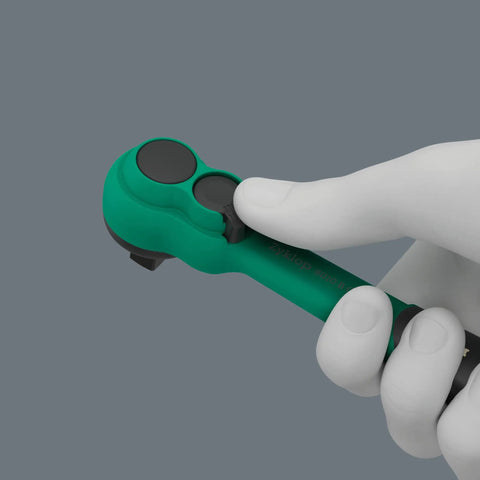 Gloved hand holding Zyklop Comfort Ratchet Set 3/8 Inch Drive, showing reversing lever and slim design in green handle.