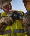 Heavy Duty 1 Inch Pistol Grip Aluminum Impact Wrench Dropping Badass 1500 Ft Lbs Torque And Lightning Fast 5500 Rpm in use at a job site.