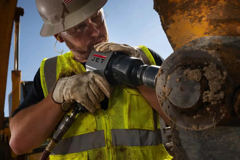 Heavy Duty 1 Inch Pistol Grip Aluminum Impact Wrench Dropping Badass 1500 Ft Lbs Torque And Lightning Fast 5500 Rpm in use at a job site.