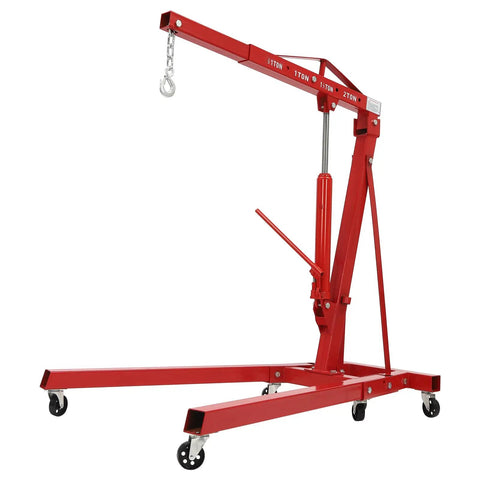 Grind House 2 Ton Folding Engine Hoist Forged From Beefy Carbon Steel With Six Greaseproof Rollers For Dead Simple Hydraulic Lifting Of Car Engines Or Axles Without Breaking A Sweat, showcasing a red hoist with wheels.