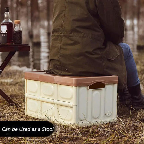 Heavy Duty Collapsible Storage Bins With Lid being used as a stool outdoors while a person sits on it.