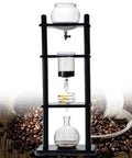 Top Shelf Cold Brew Maker And Ice Coffee Machine Harnessing Steady Slow Drip Technique For A Seriously Smooth Full Extract, three-tiered glass and wood rack.