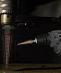 Close-up of a Cobalt Step Drill Bit Set With 1/4 Inch Hex Shank drilling into metal with an electric drill