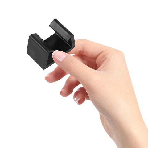 Hand holding black clip from 4 Pack Sectional Sofa Clips And Patio Furniture Fasteners Lightweight Wicker Rattan Couch Clamps Easy Connectors