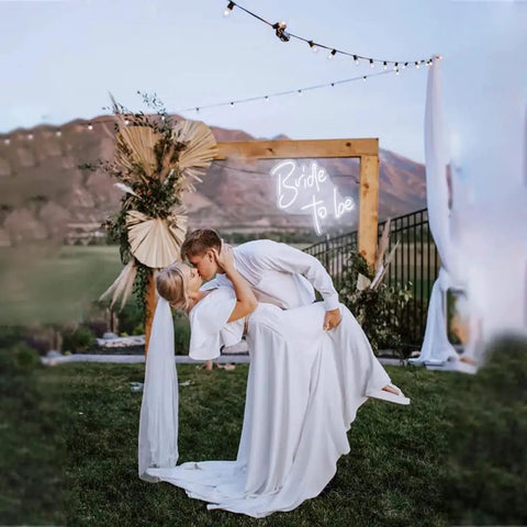 Couple dancing outdoors with Bride To Be Neon Sign For Wall Decor LED Neon Light For Bachelorette Party White Glow Dimmer