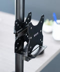 Slick And Durable Mini PC Mount Bracket Providing A Rock Solid VESA Under Desk And Monitor Arm Computer Holder For Thin Client CPU Docking Station No Sweat Setup Black mounted on a support pole.