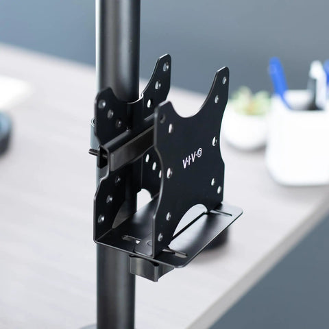 Slick And Durable Mini PC Mount Bracket Providing A Rock Solid VESA Under Desk And Monitor Arm Computer Holder For Thin Client CPU Docking Station No Sweat Setup Black mounted on a support pole.