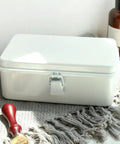 Heavy Duty Vintage White Metal Toolbox Featuring A Tight Snap Shut Locking Latch Tin Storage Case For Everyday Gear And Art Supplies Classic Secure Organizer Trunk on a textured surface.