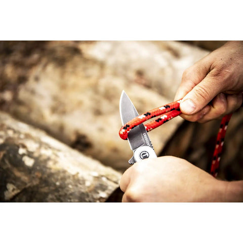 3 1/4 Inch Drop Point Pocket Knife With Aluminum Handle, cutting rope outdoors, showcasing ergonomic grip and D2 Steel Blade.