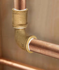 1-inch brass street elbow joining copper pipe with male and female NPT fittings