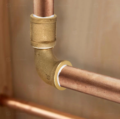 1-inch brass street elbow joining copper pipe with male and female NPT fittings