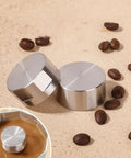 Moka Pot Guard Stainless Steel Spray Cap Anti Splash Shield for Moka Coffee Pot Easy to Clean Silver Hexagonal Design Keeps No Mess Spill Proof and Rust Free Premium 304 Stainless Steel Accessory, shown on coffee beans with an installed view