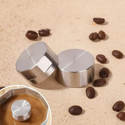 Moka Pot Guard Stainless Steel Spray Cap Anti Splash Shield for Moka Coffee Pot Easy to Clean Silver Hexagonal Design Keeps No Mess Spill Proof and Rust Free Premium 304 Stainless Steel Accessory, shown on coffee beans with an installed view