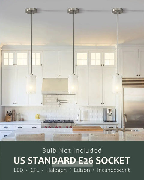 One Light Mini Pendant With White Frosted Shade, Brushed Nickel Finish over a modern kitchen island, sloped ceiling friendly.