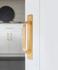 Close-up of 5-Inch Brushed Gold Cabinet Pulls With Base Plate Aluminium Alloy Square Kitchen Cabinet Handles Drawer Pulls installed on a door.