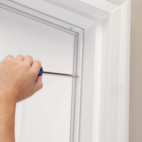 Installing White Aluminum And Vinyl Door Seal Kit With Screw On Top And Sides Blocks Drafts Moisture Dust And Insects
