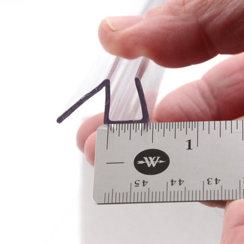Close-up of Frameless Shower Door Bottom Seal For 3/8 Inch Glass, 36 Inch Length, Clear Vinyl Slip On Fit, with ruler for scale