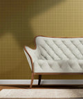 Next Level Neutral Plaid Tan And Gold Metallic Wallpaper With Luxe Fiber Texture Eco Friendly Pvc Free Wallcovering Made In Usa showcased behind a white tufted sofa.